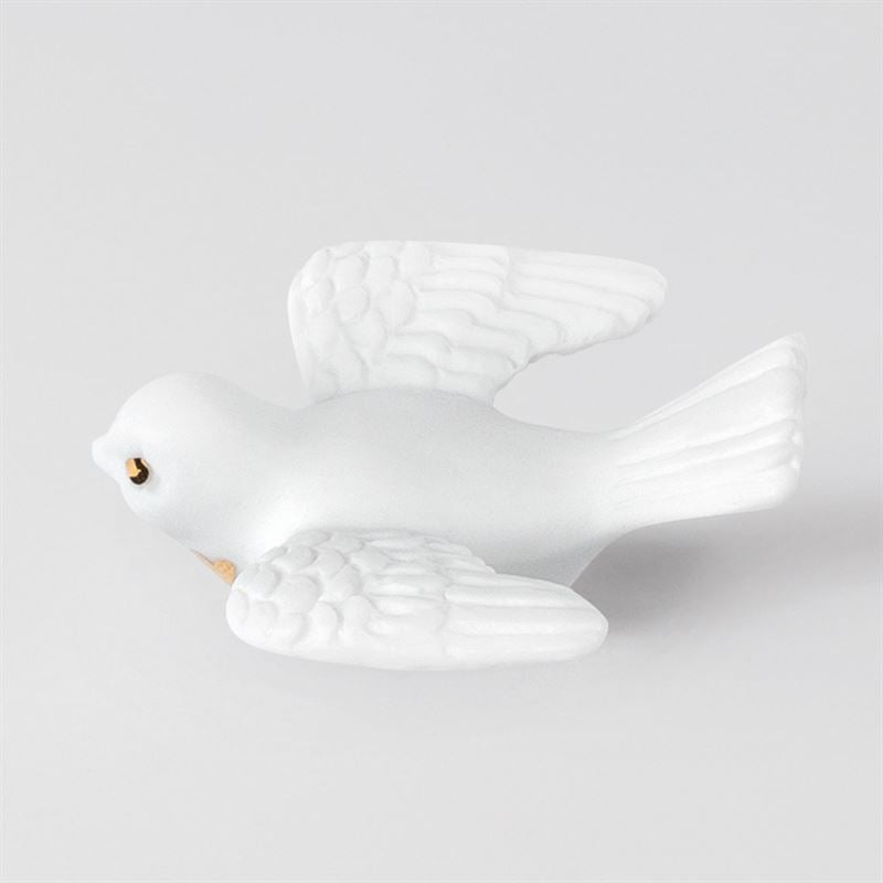 White ceramic dove on a light gray background