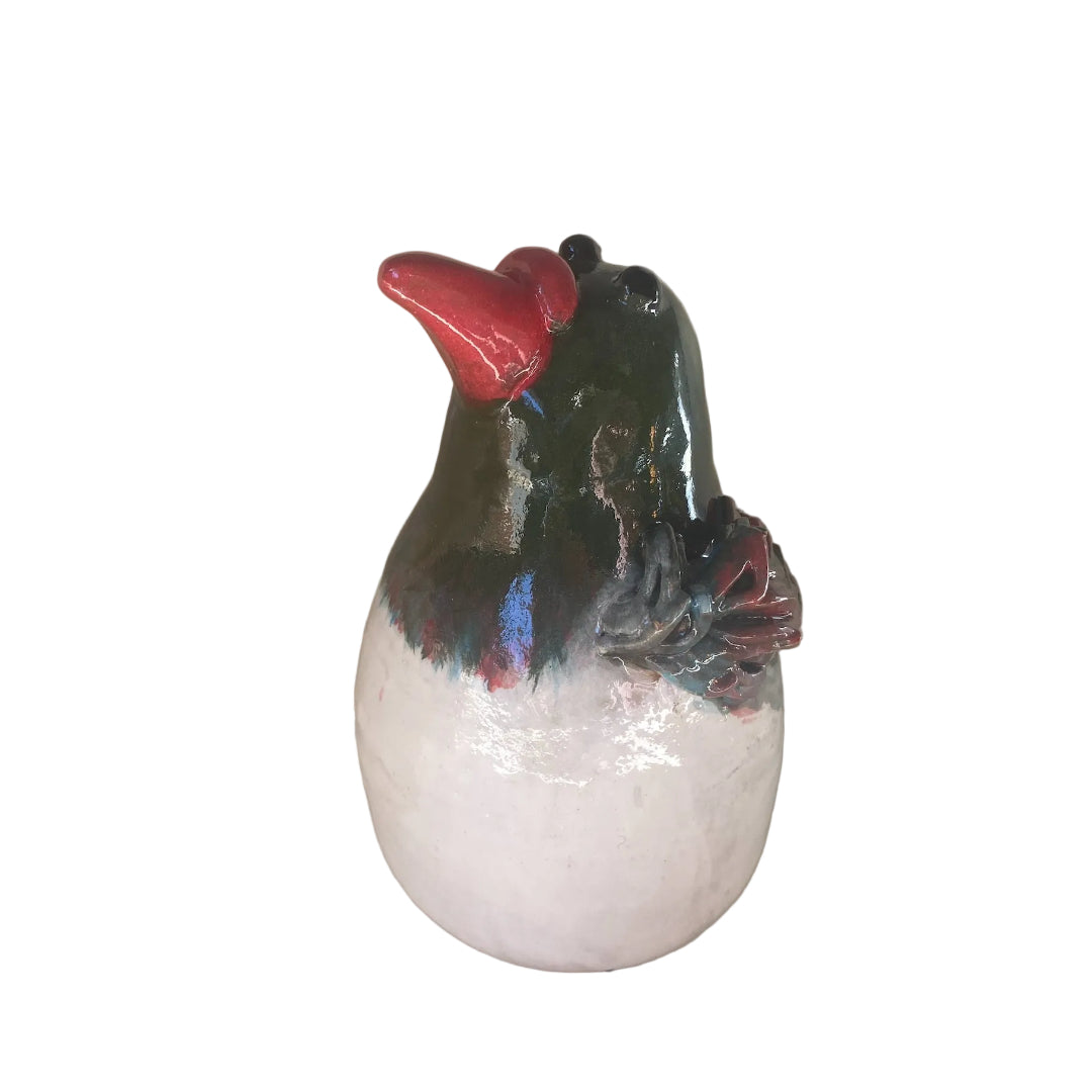 Ceramic Kereru bird sculpture with a red beak on a white background
