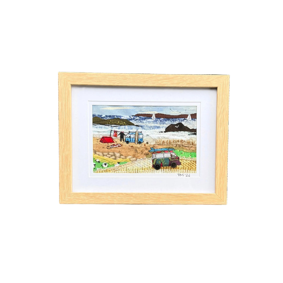 Textile artwork showing 2 vans at the beach.