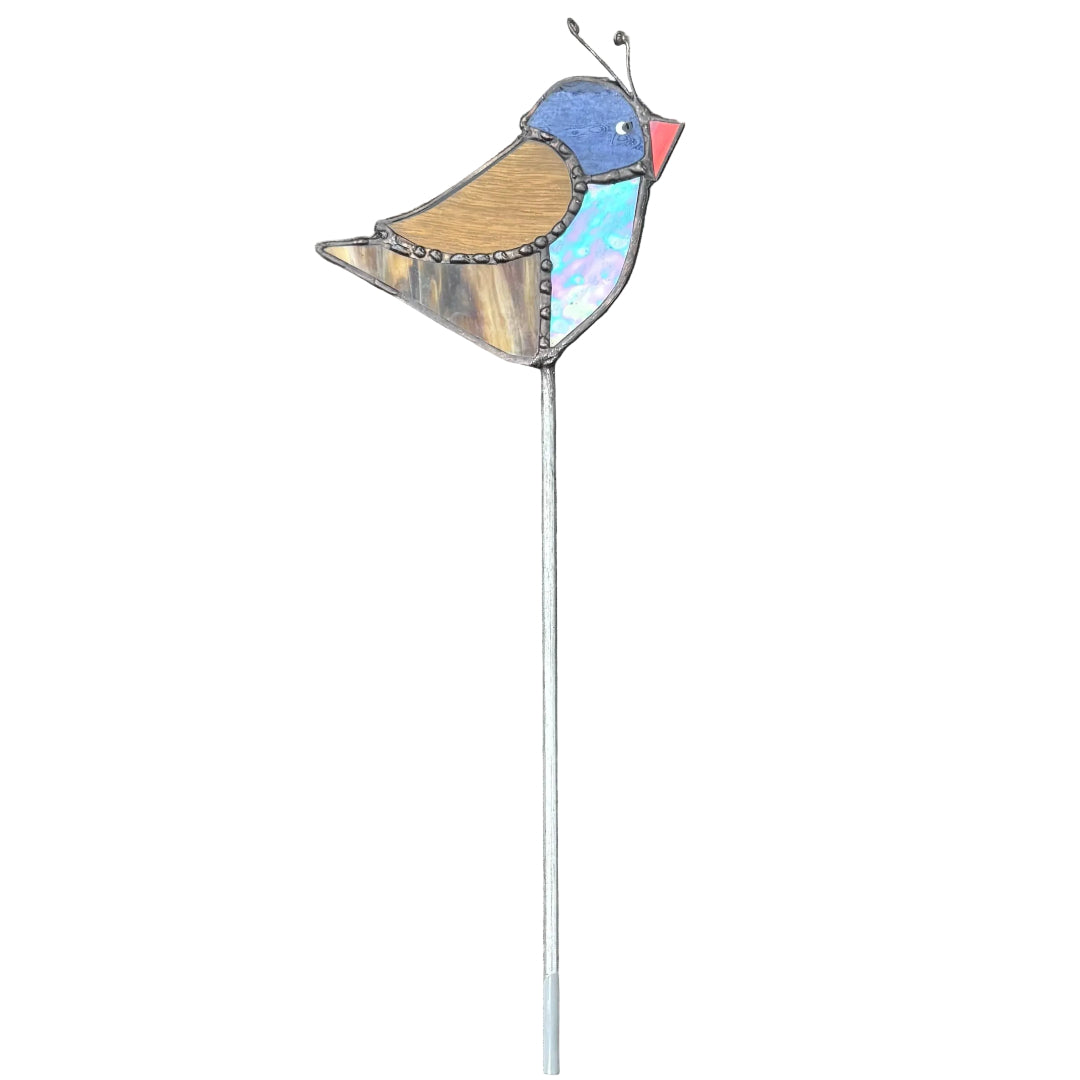 A decorative metal bird garden stake with a long silver stem, featuring a bird design with a blue head, brown wing, iridescent turquoise body, and red beak, set against a white background.
