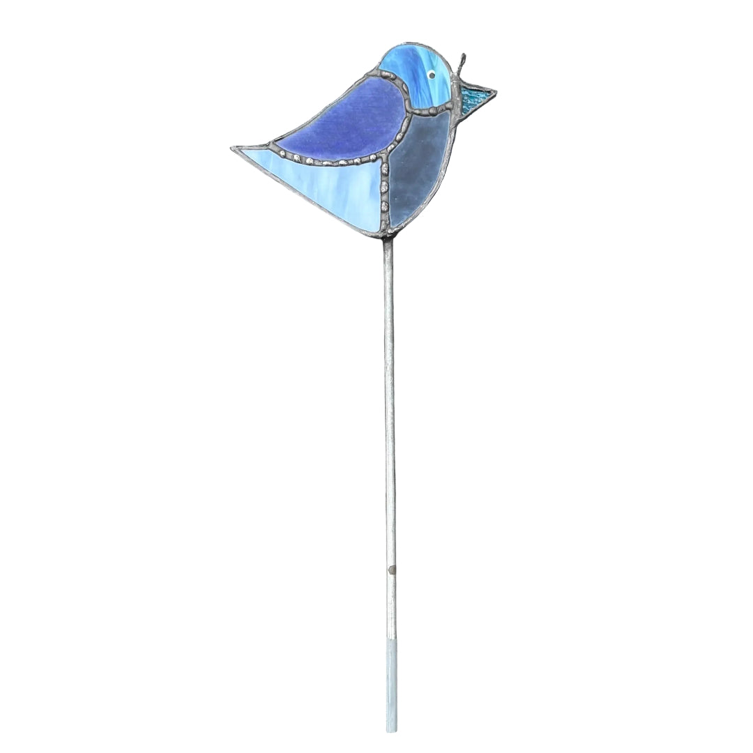 A bird-shaped garden stake or decoration with a blue and light blue marbled glass body and a long silver metal stem, photographed on a white background.