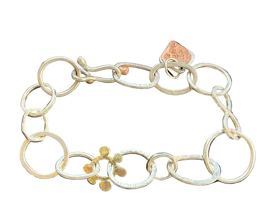 Silver bracelet with a gold detail on a white background.