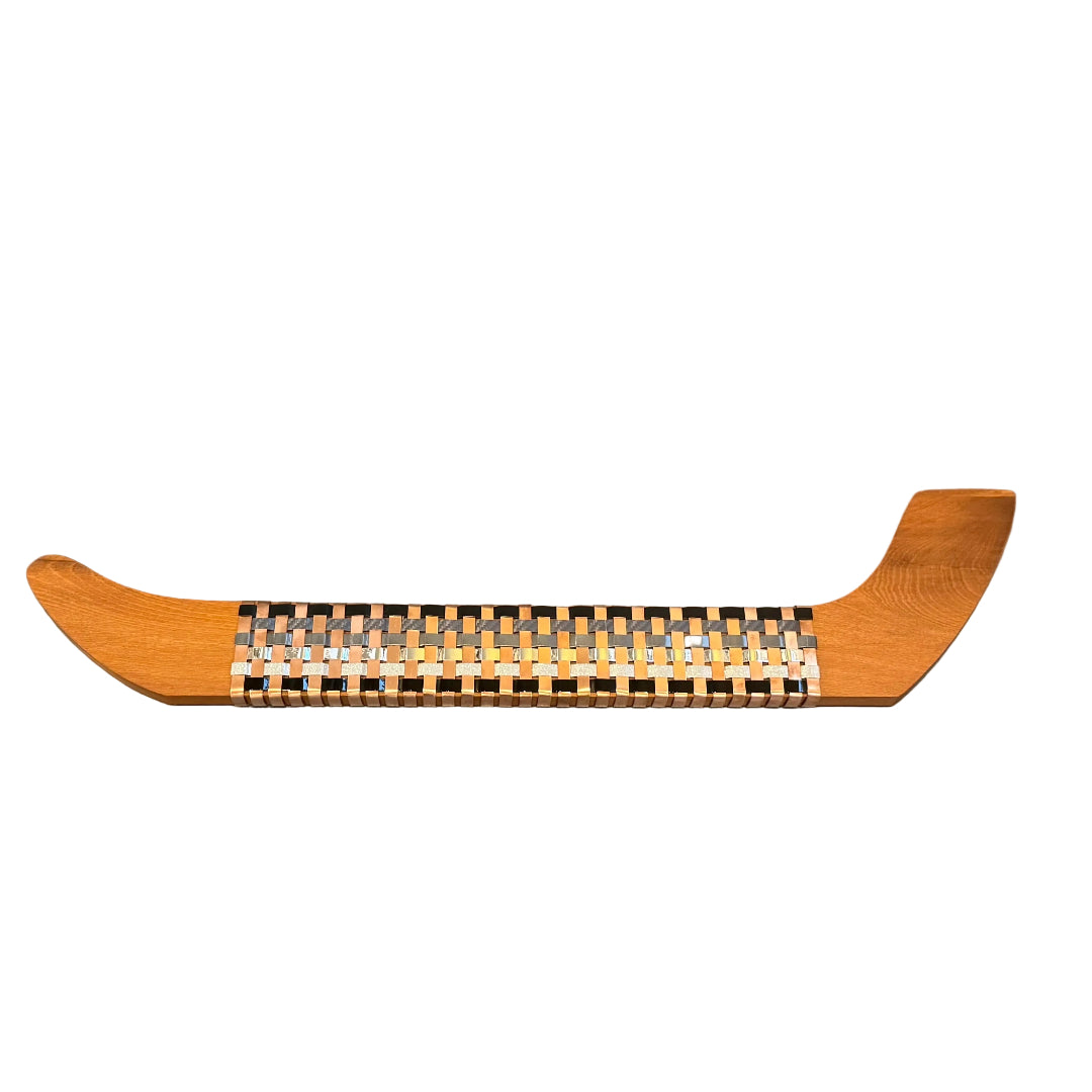 Wooden wall waka with woven copper & aluminium on a white surface