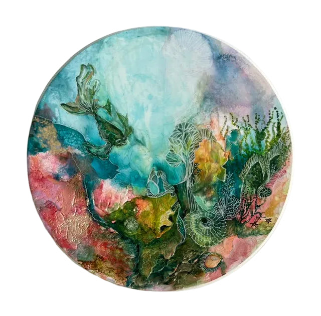 Round artwork with colorful underwater scene on a white background