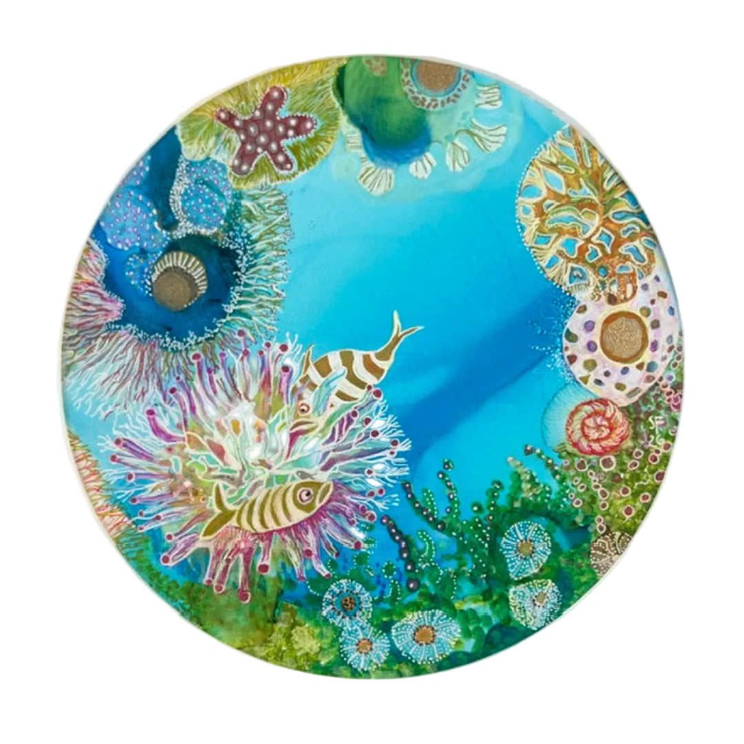 Colorful circular artwork with sea-themed elements on a white background