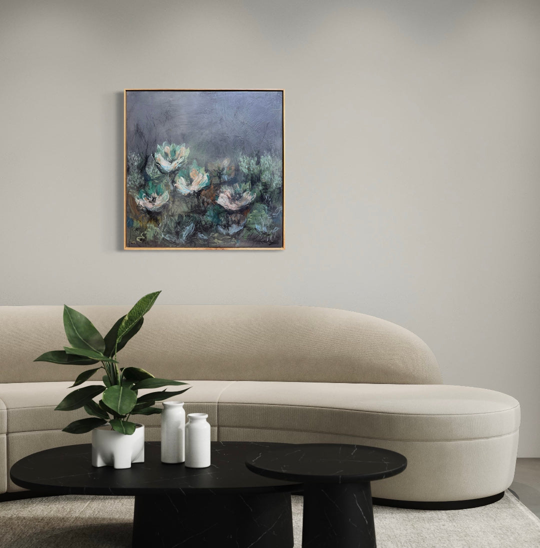 Modern living room with a beige sofa, black coffee table, and floral painting on the wall.