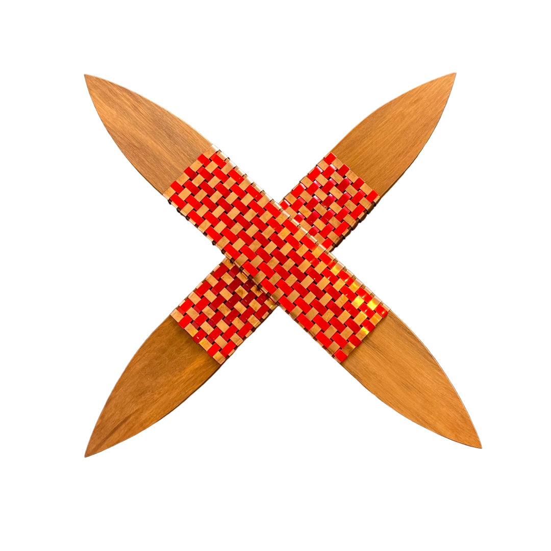 Wooden star-shaped object with red woven center on a white background