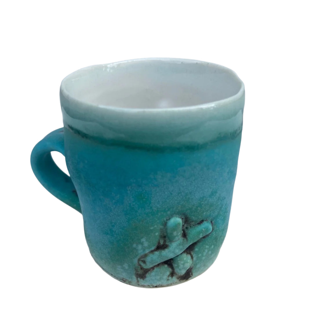 Turquoise Cup with X and 3 Staples