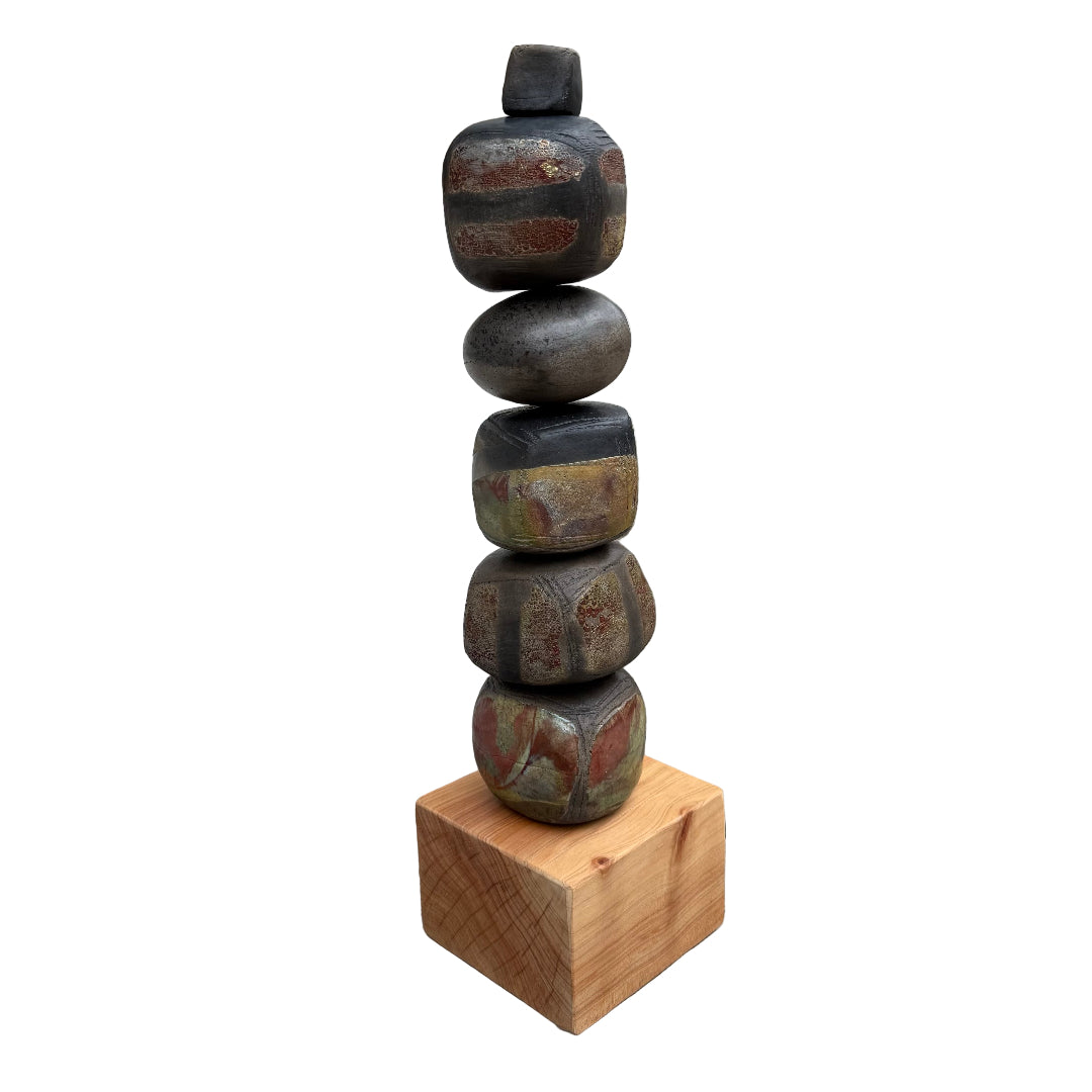 Stack of raku fired ceramic stones on a wooden block