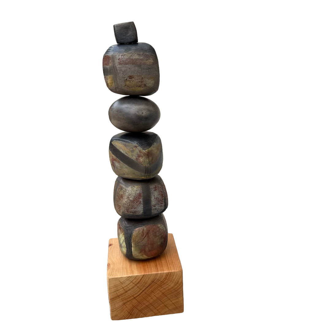Stack of raku fired ceramic stones on a wooden block