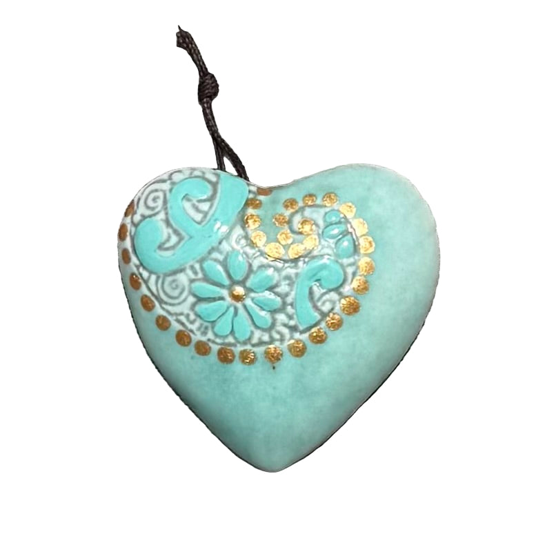 Turquoise ceramic hanging heart with gold embossing on a white surface