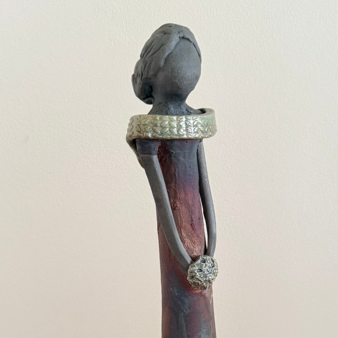Decorative ceramic sculpture of a woman on a plain background background