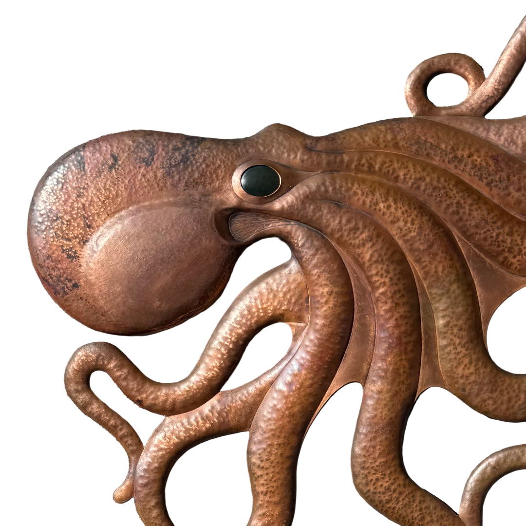 Copper octopus sculpture on a white background