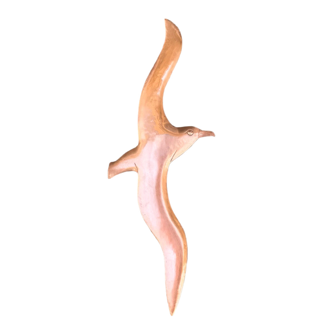 Copper Albatross bird sculpture on a wooden surface