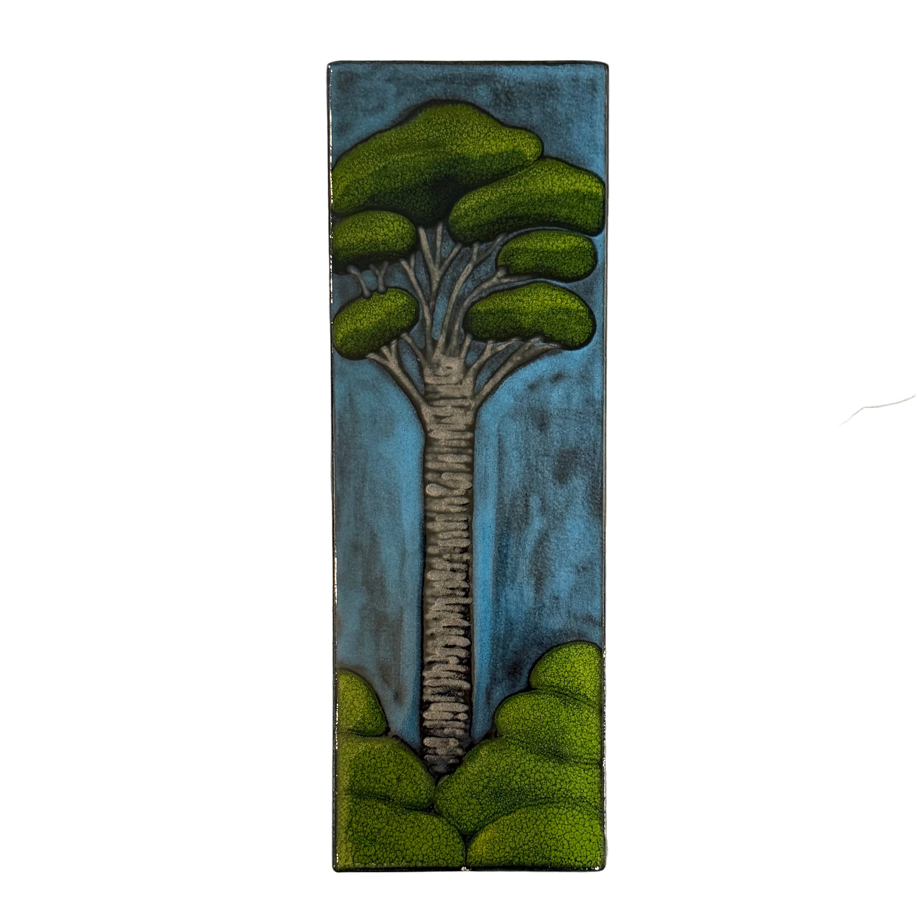 Decorative tile with a Kauri tree design on a white background