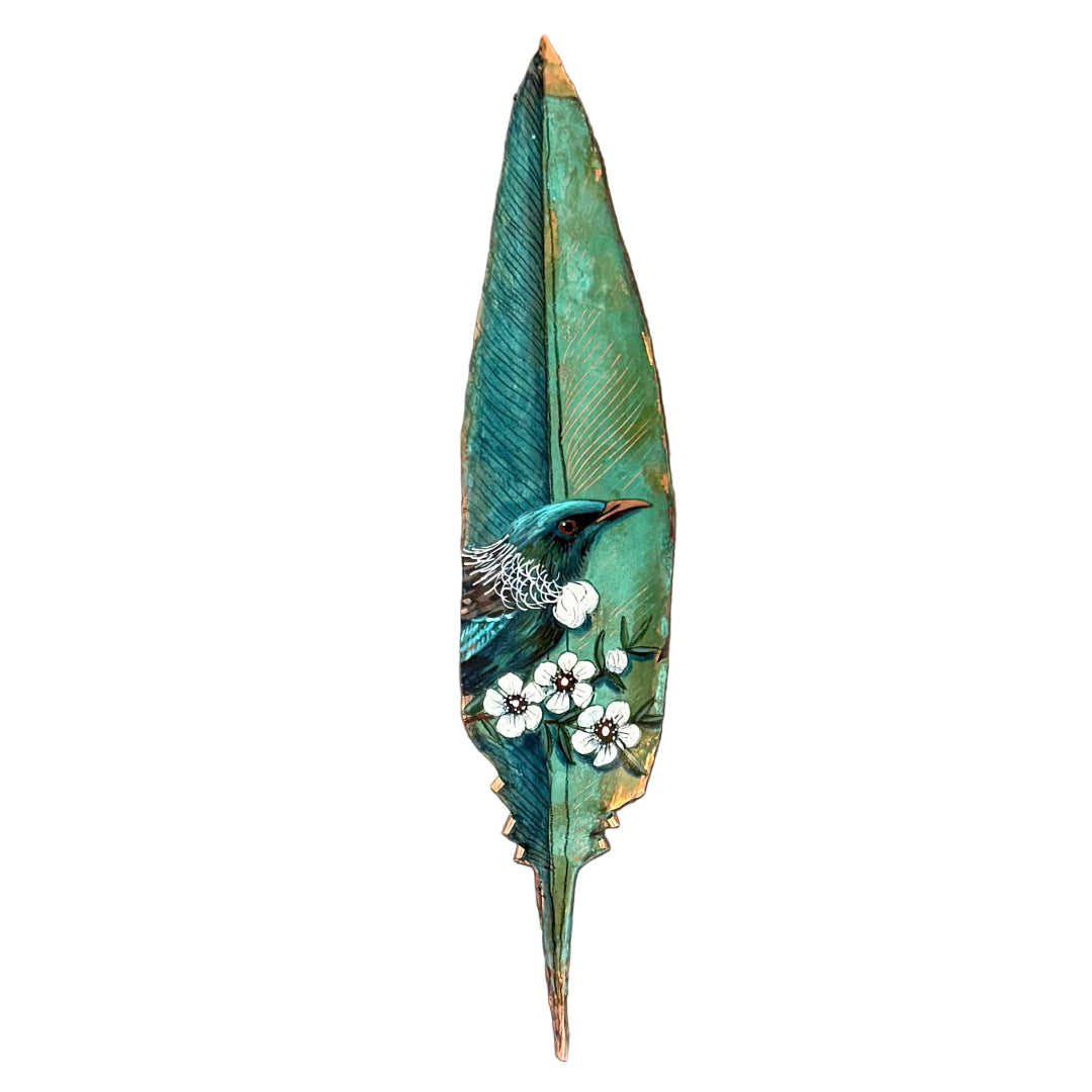 Decorative copper feather with a painted Tui bird on a white background