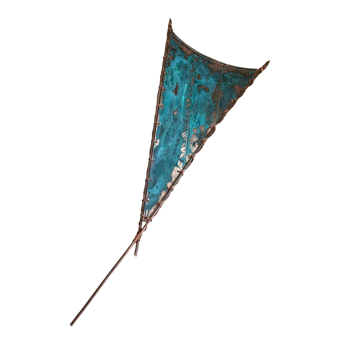 Decorative copper wall art sail with green blue patina on a white background.