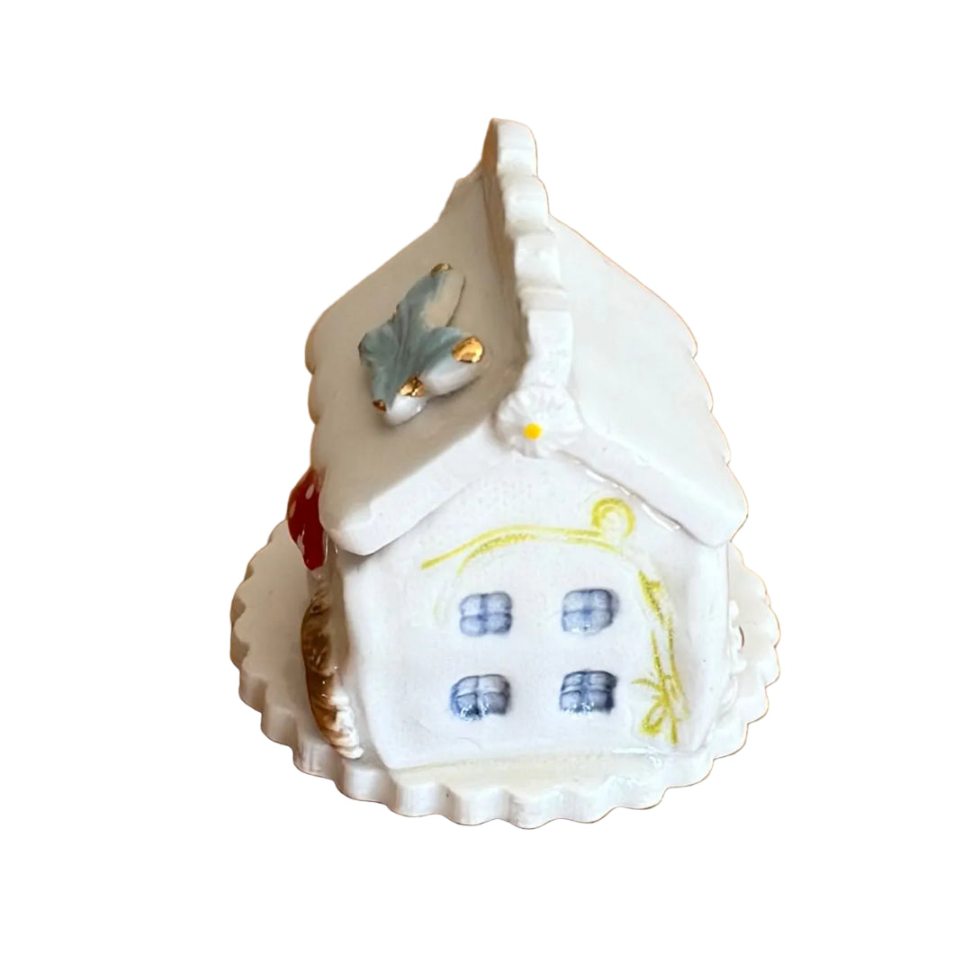 Decorative ceramic trinket box small house with 'Tooth Fairy' text on a white surface