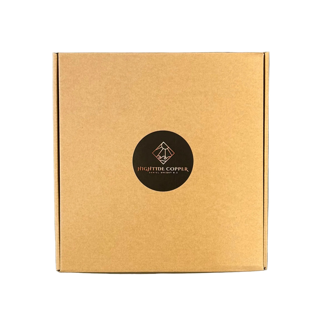 Brown cardboard box with a black circular logo on a white surface