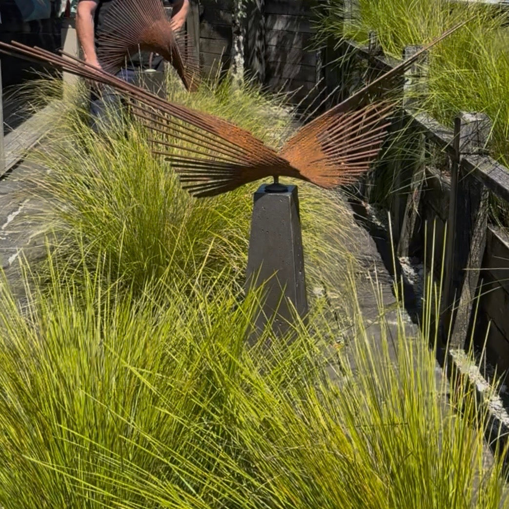 Decorative metal sculpture among tall grasses