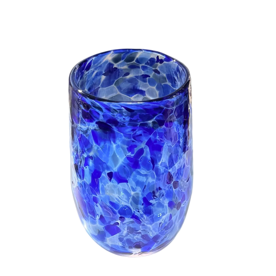 Blue multicoloured glass tumbler on a white surface