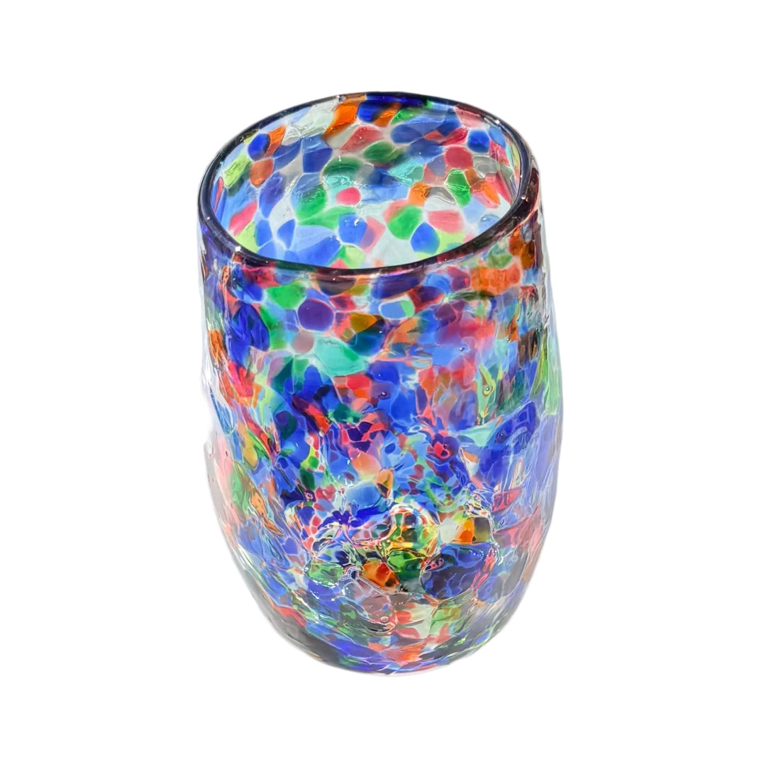 Multicolored glass tumbler on a white surface