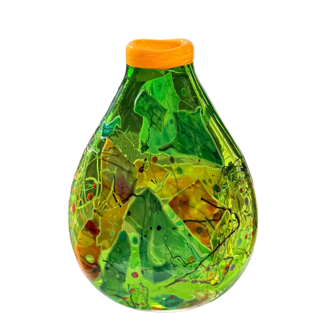 Decorative glass vase with green and yellow design on a white surface