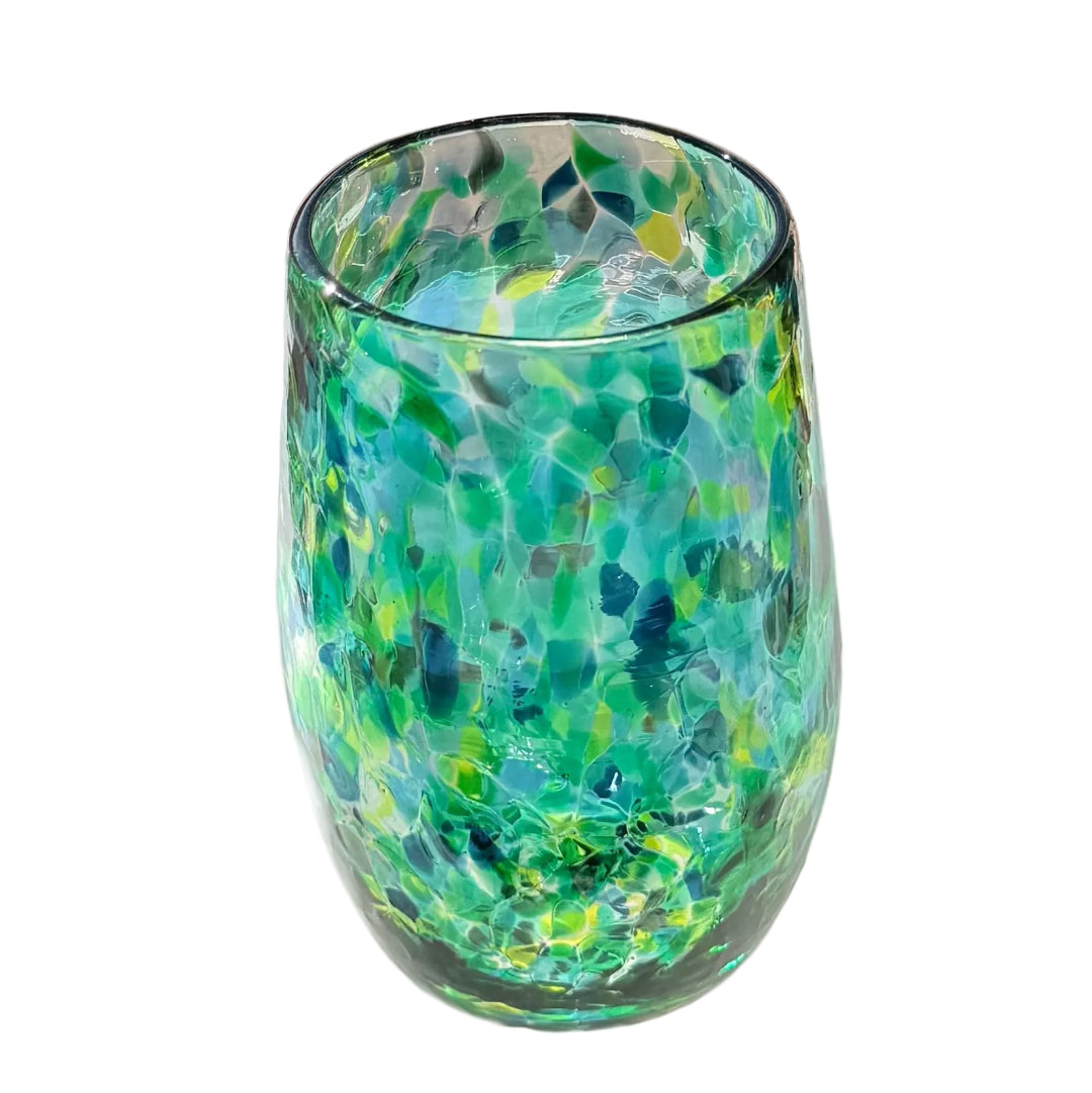 Green and blue patterned glass on a white surface