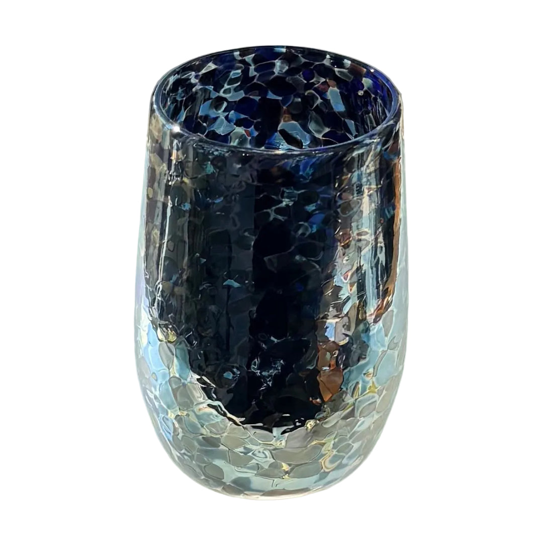 Glass tumbler with blue, black and silver lustre pattern on a white surface