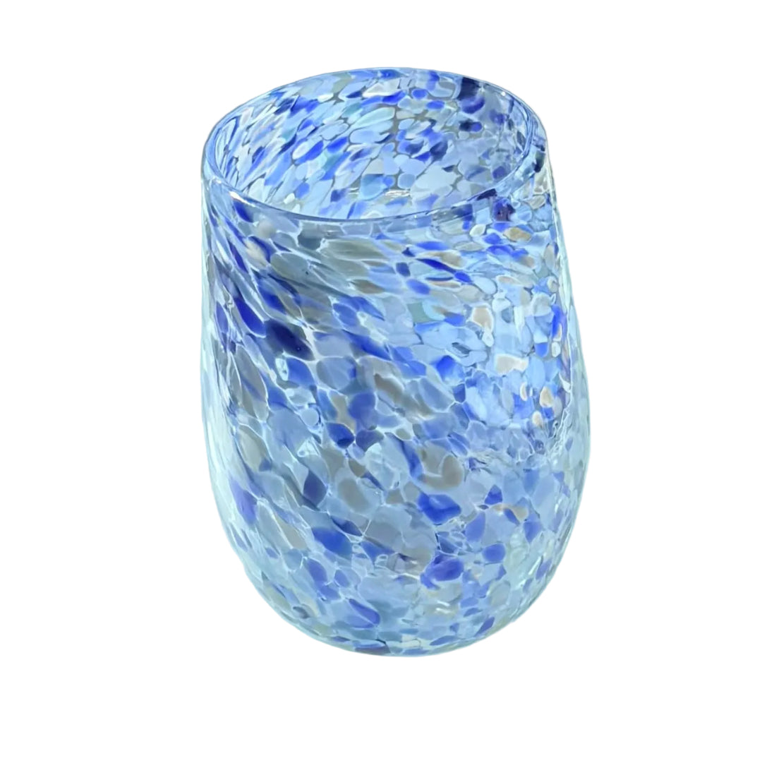 Blue and white patterned glass tumbler on a white surface