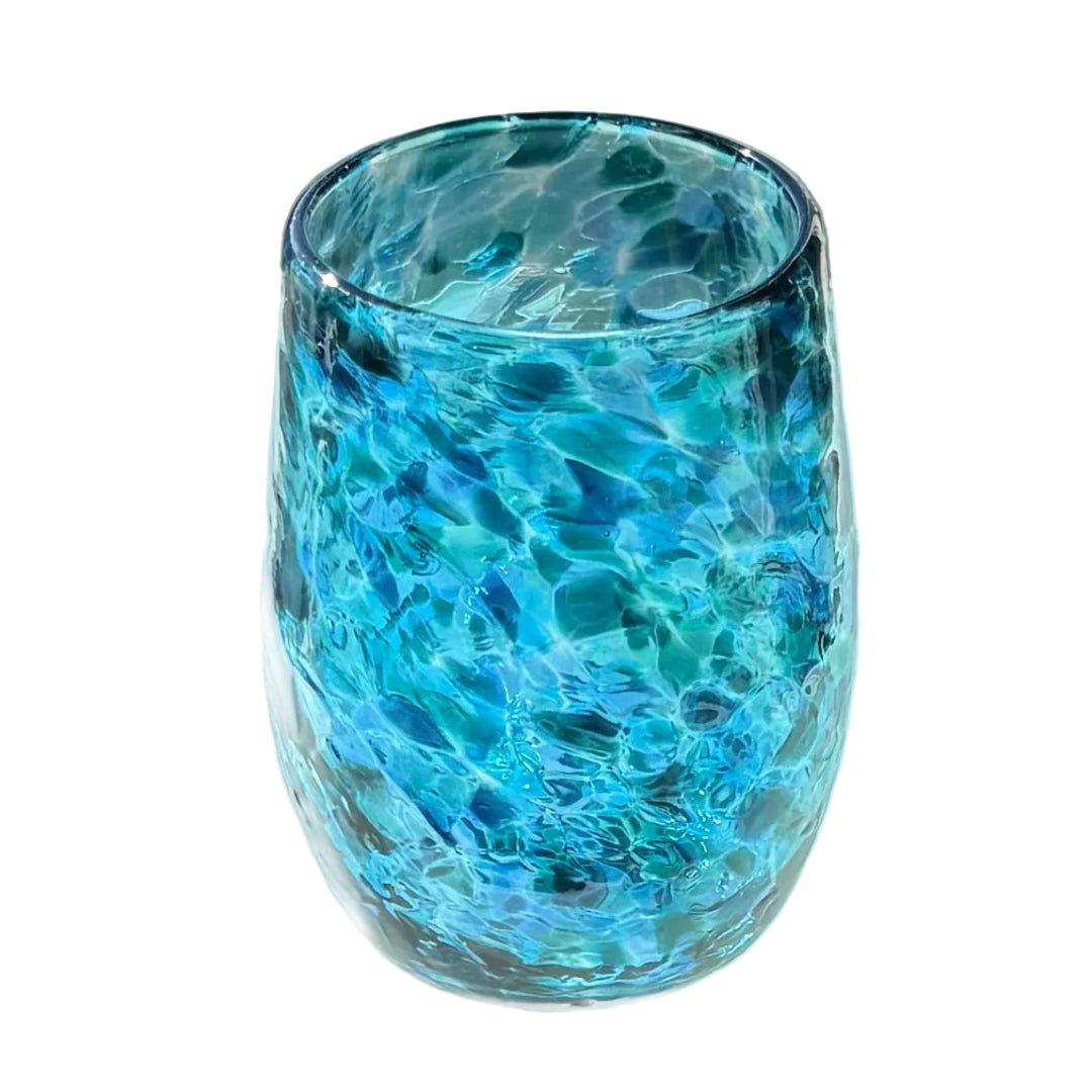 Blue multicoloured glass tumbler on a white surface