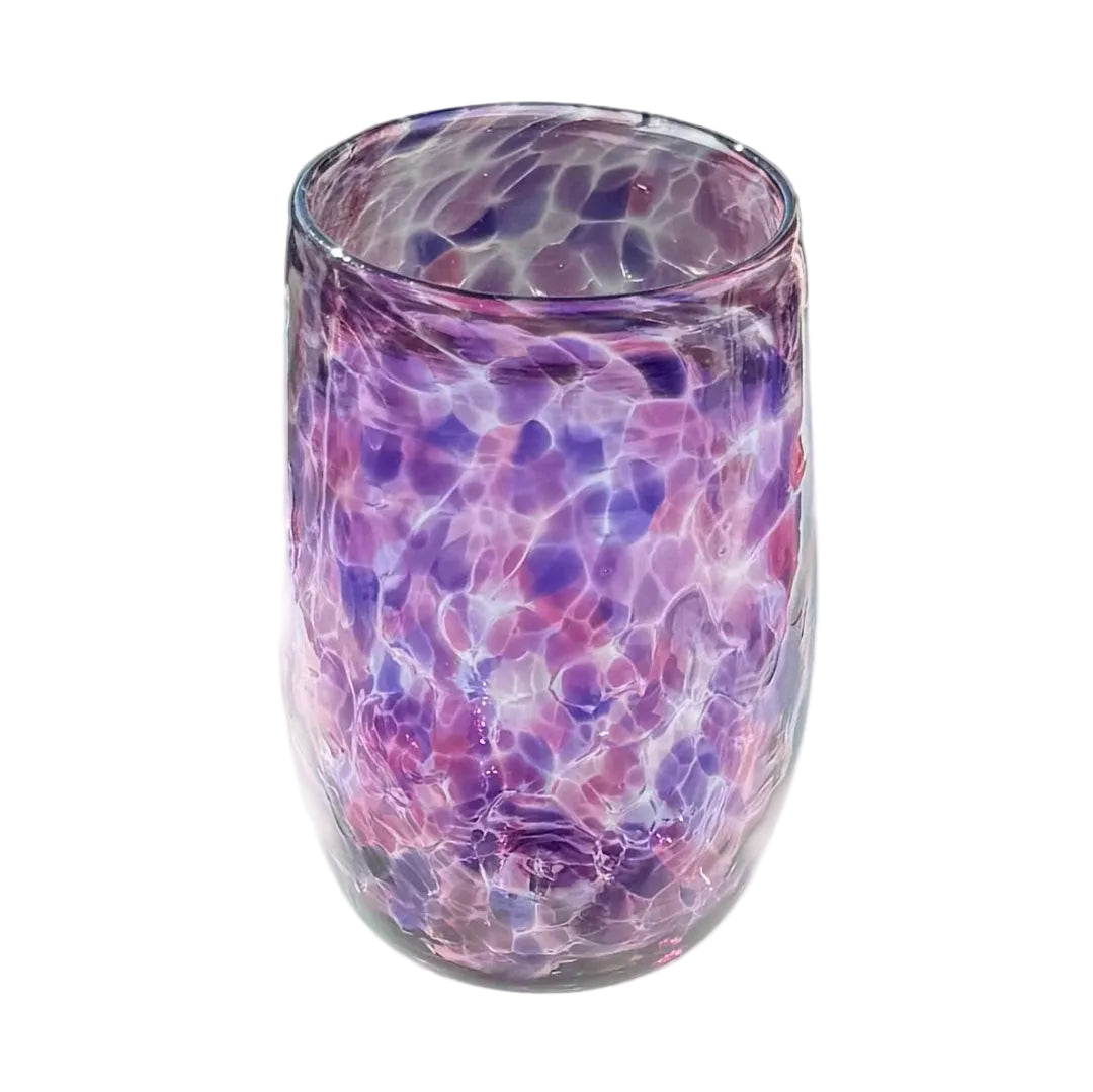 Glass tumbler with purple and pink marbled pattern on a light gray surface.