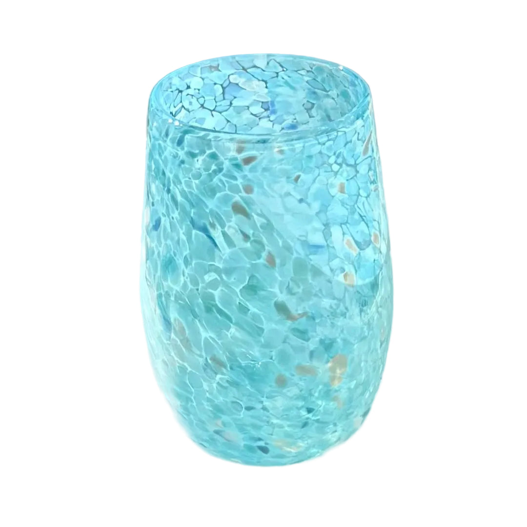 Blue textured glass cup on a reflective surface