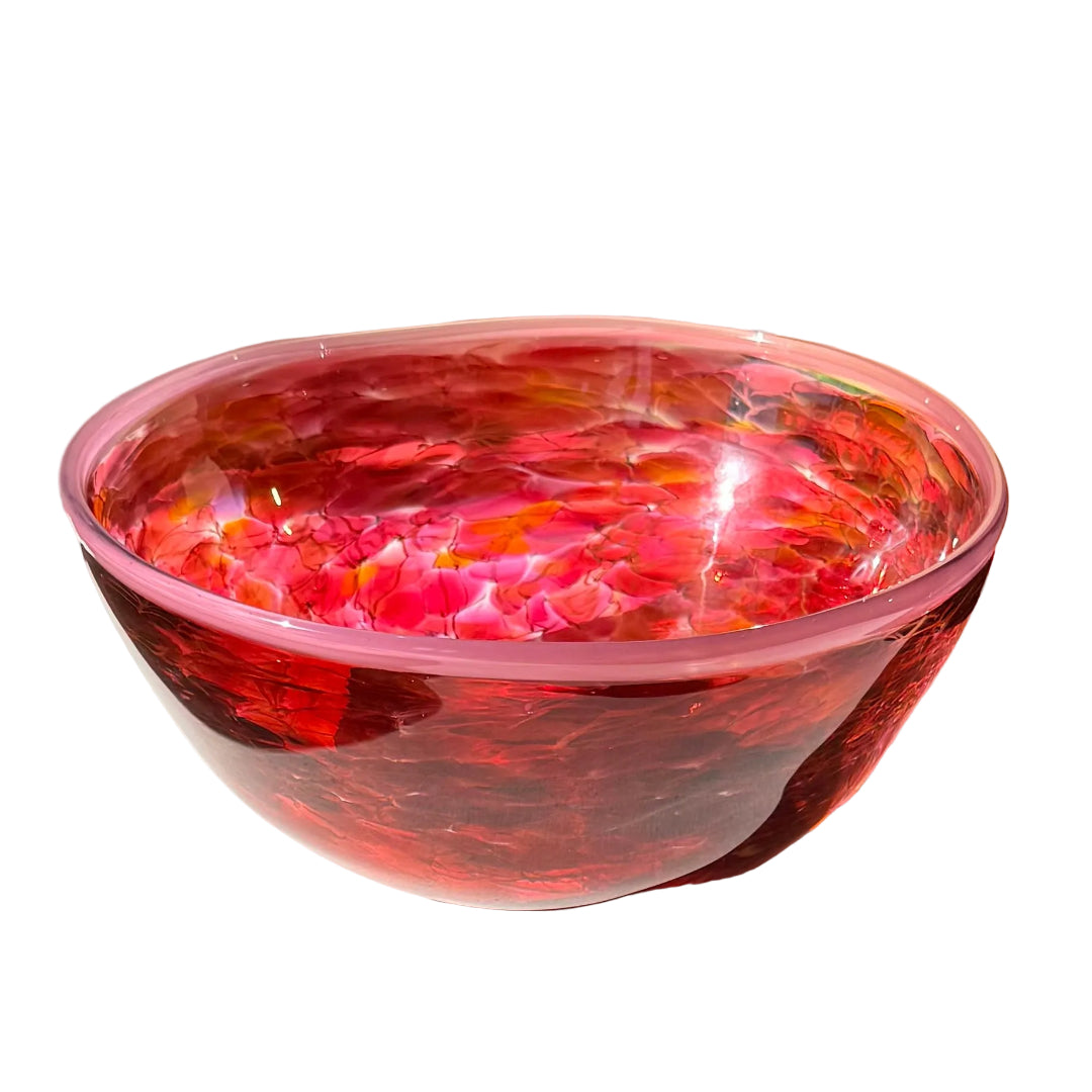 Pink and red glass bowl on a white surface