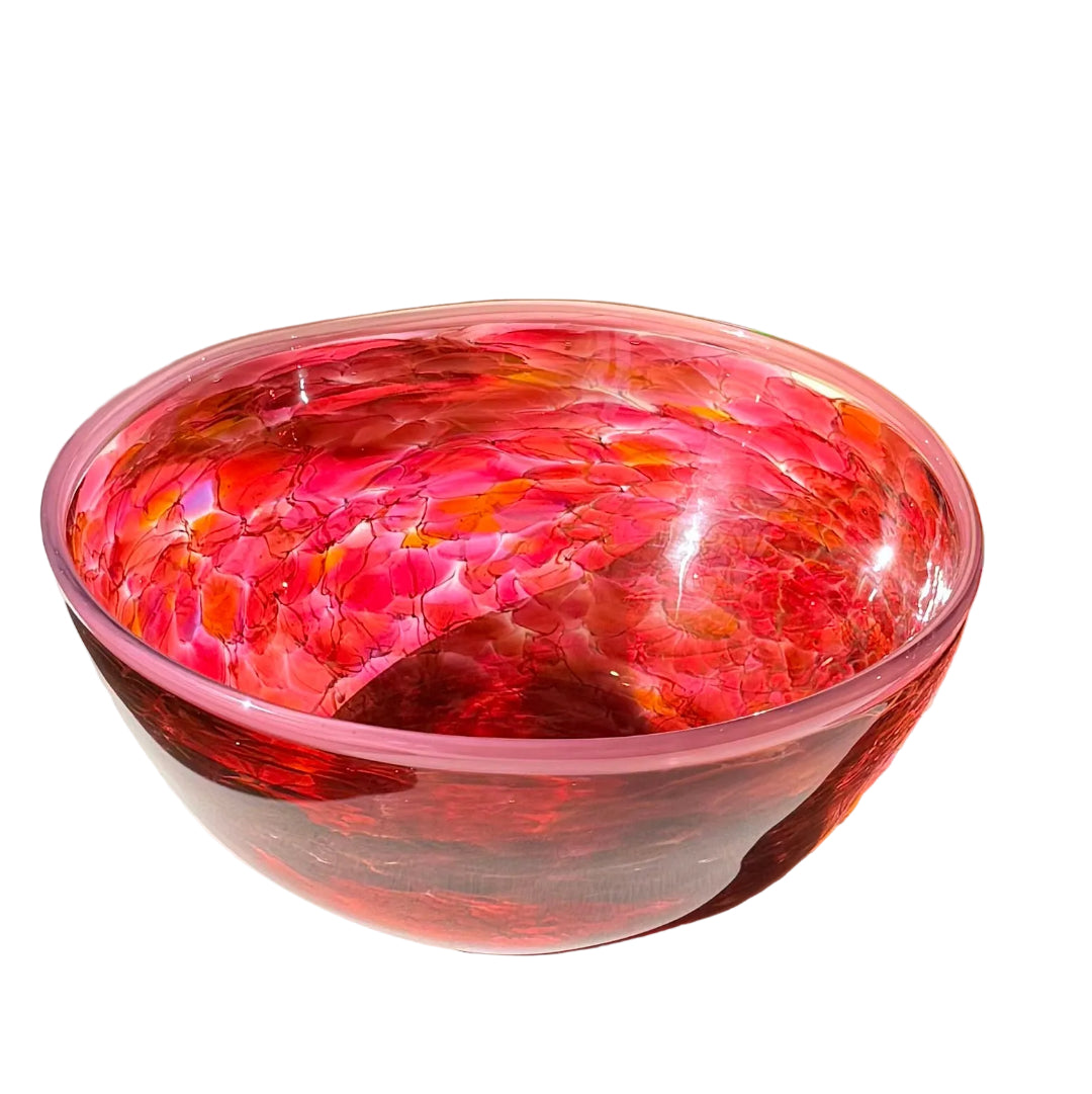 Pink and red glass bowl on a white surface