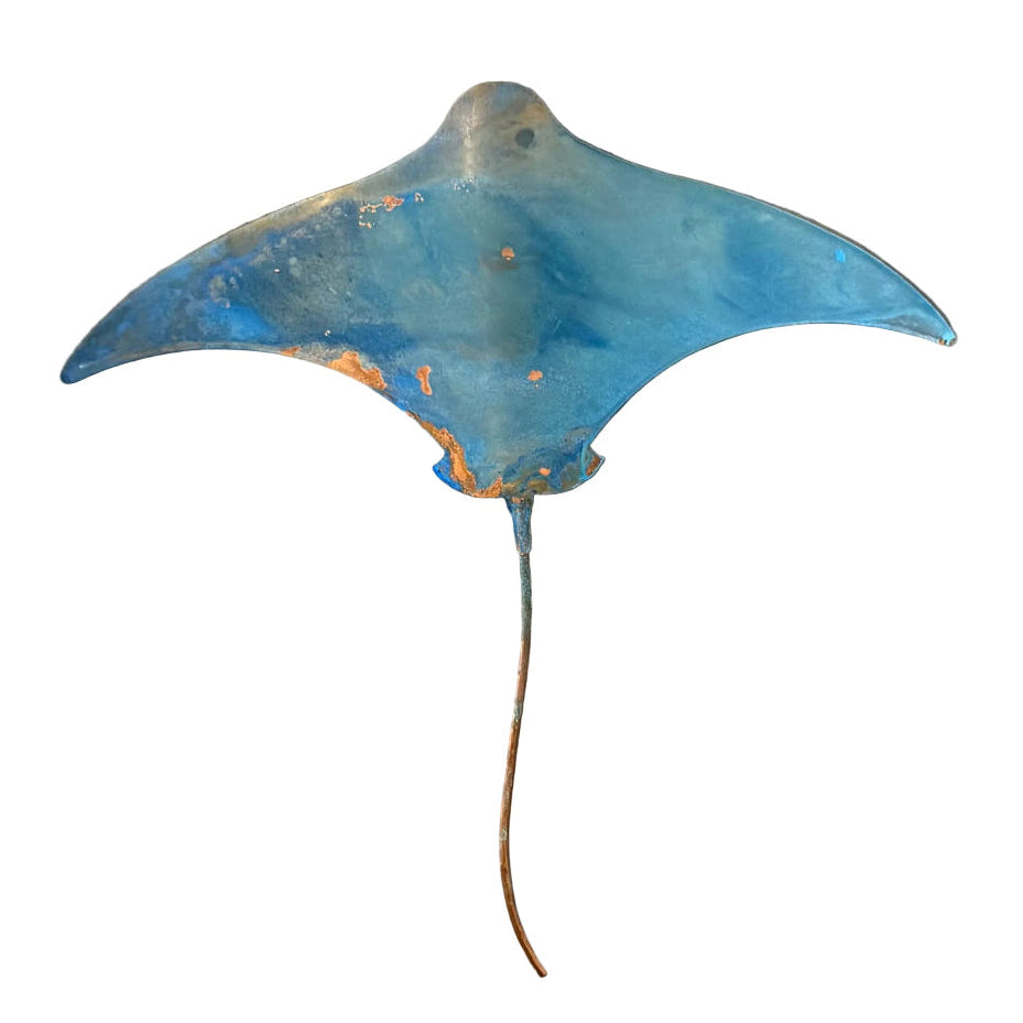 Blue stingray copper wall sculpture on a white surface