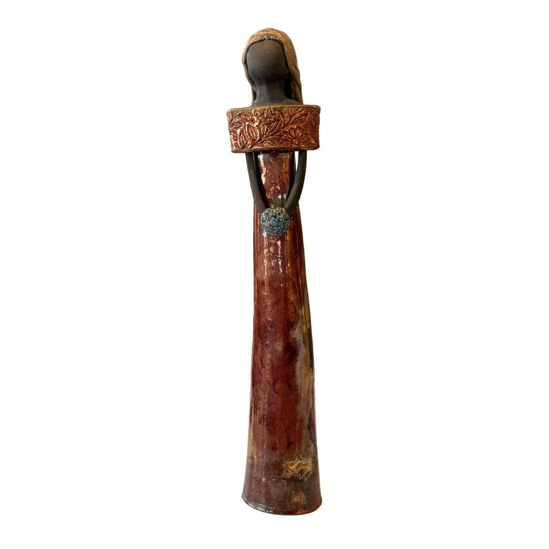 A tall decorative figurine with a dark brown and bronze textured body.