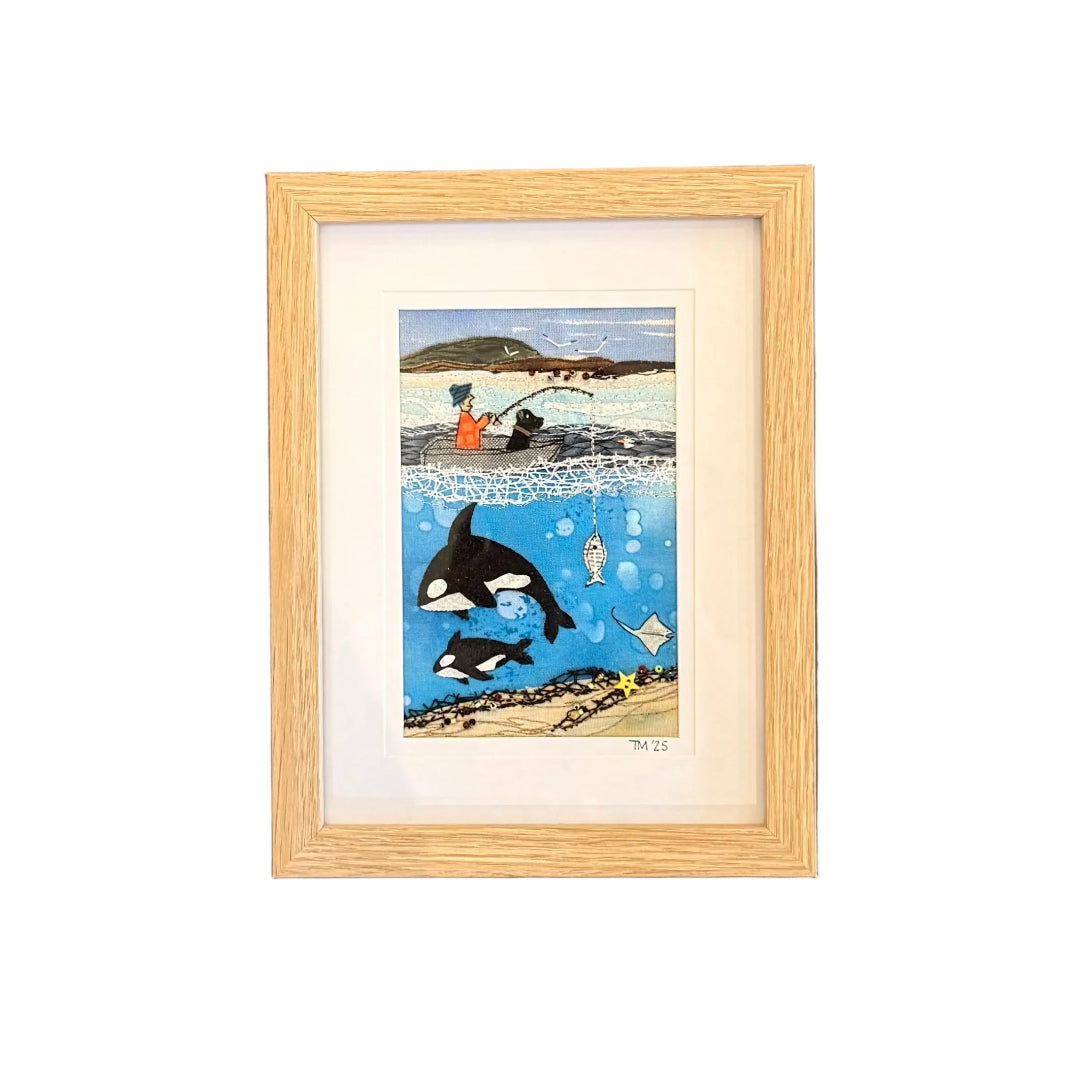Framed artwork of a fisherman with orca on a white wall