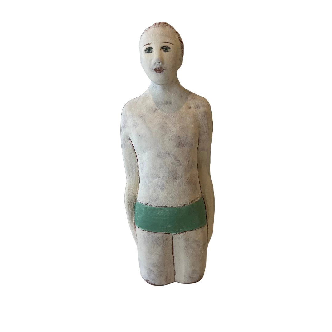 Ceramic male Swimmer in jade trunks on a white background.