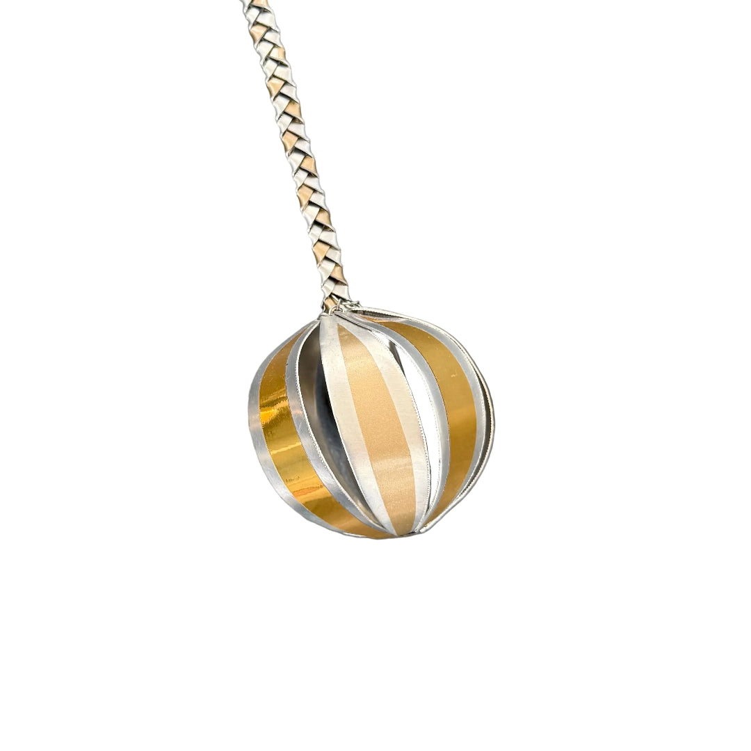 Close up view of a single silver & gold aluminium poi with a white background