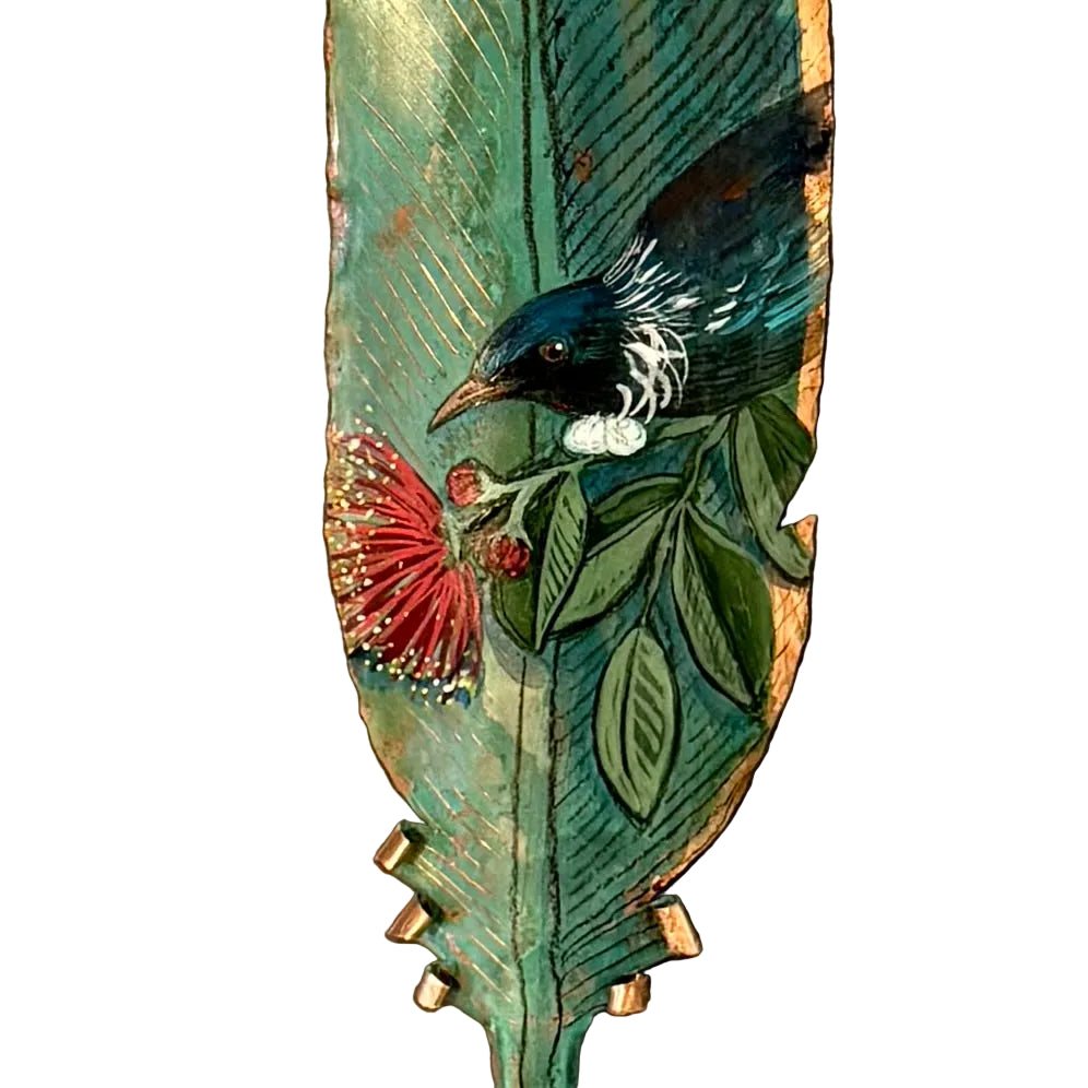 Close up of a copper feather with a painted Tui bird on pohutakawa flower on a white background