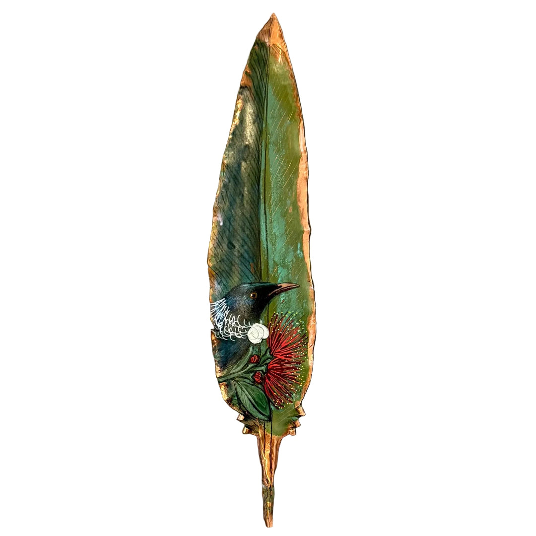 Decorative copper feather with a painted Tui bird on pohutakawa flower on a white background