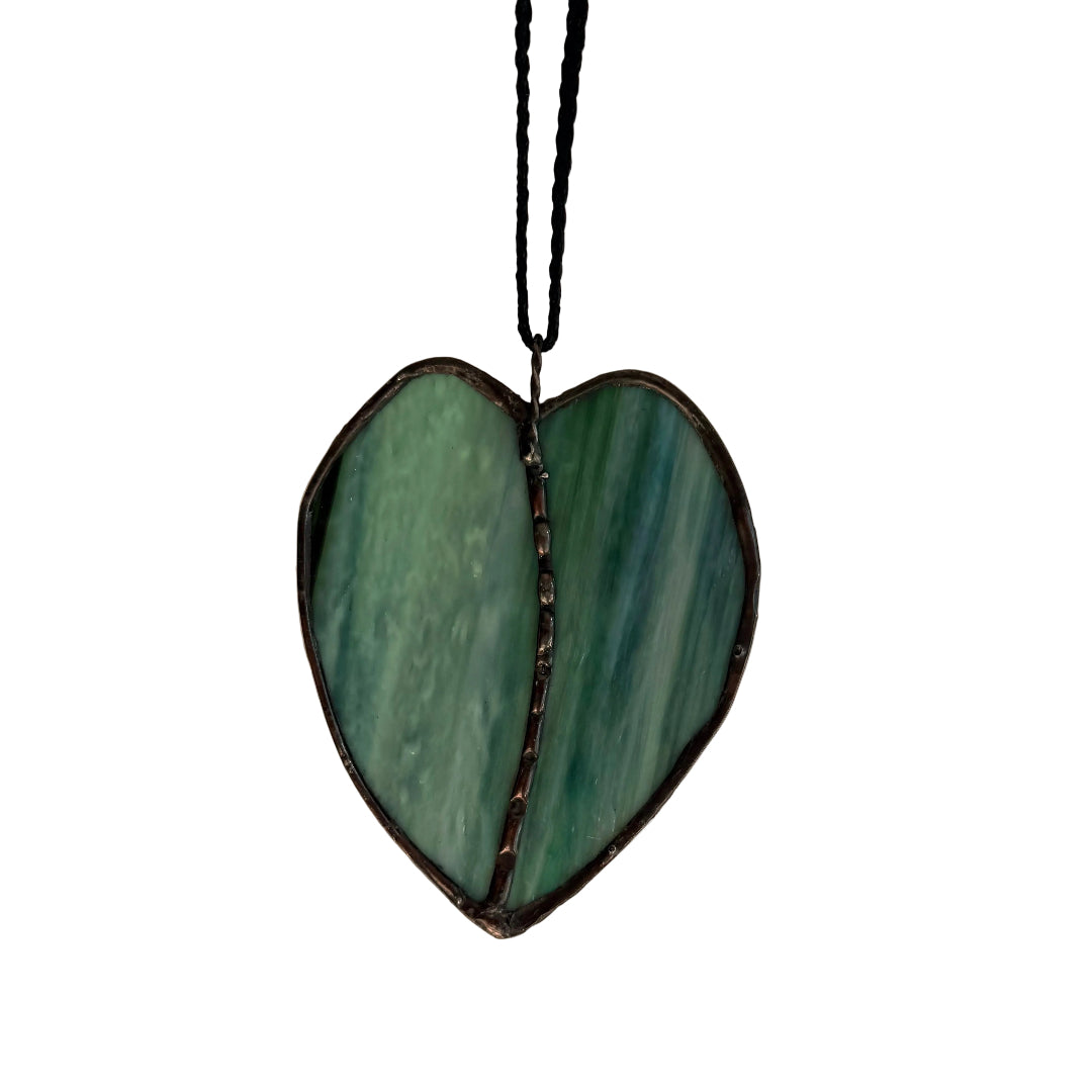 Leaf-shaped stained glass wall hanging on a white background