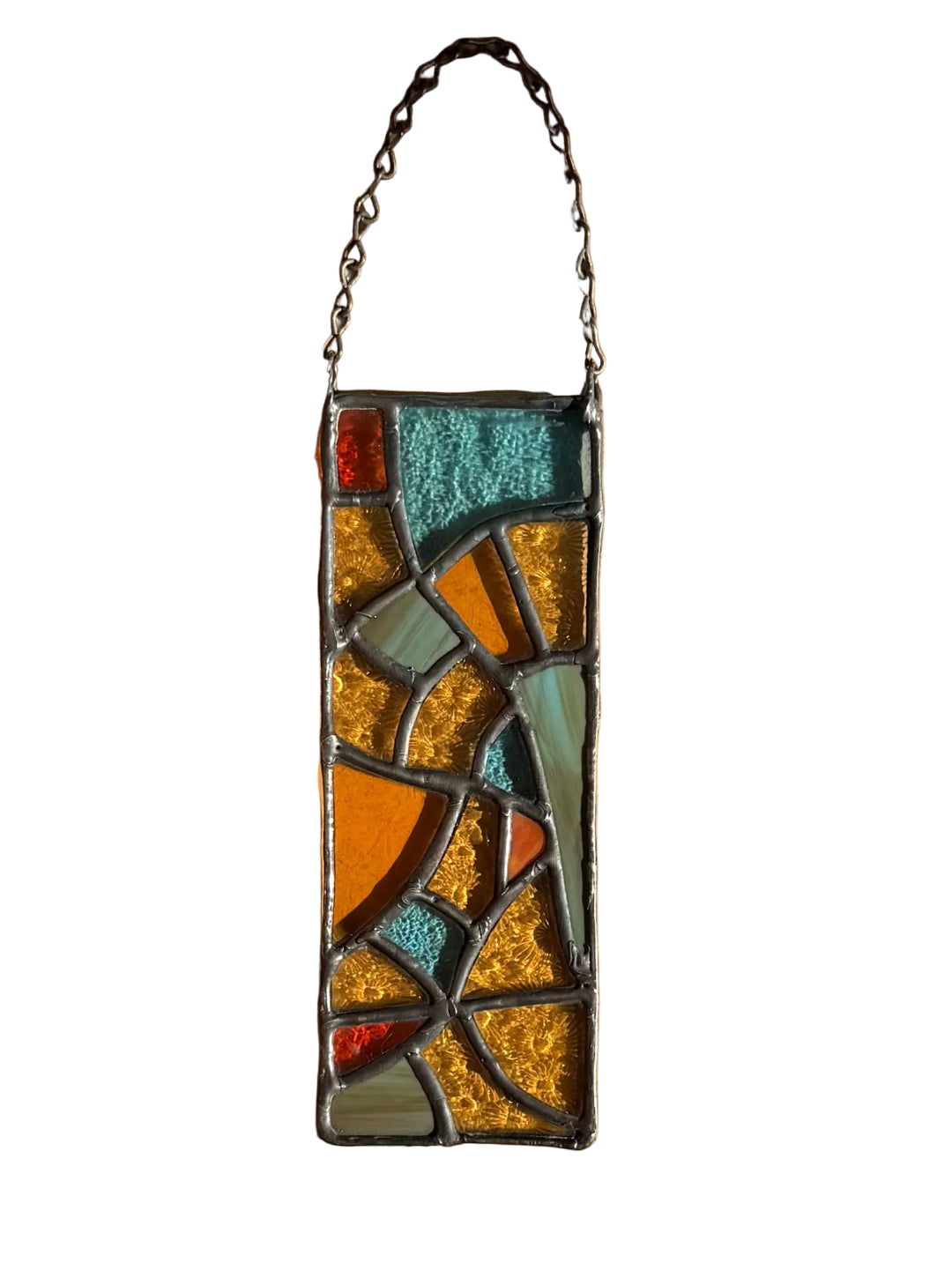 Stained glass panel with colorful mosaic design on a white surface