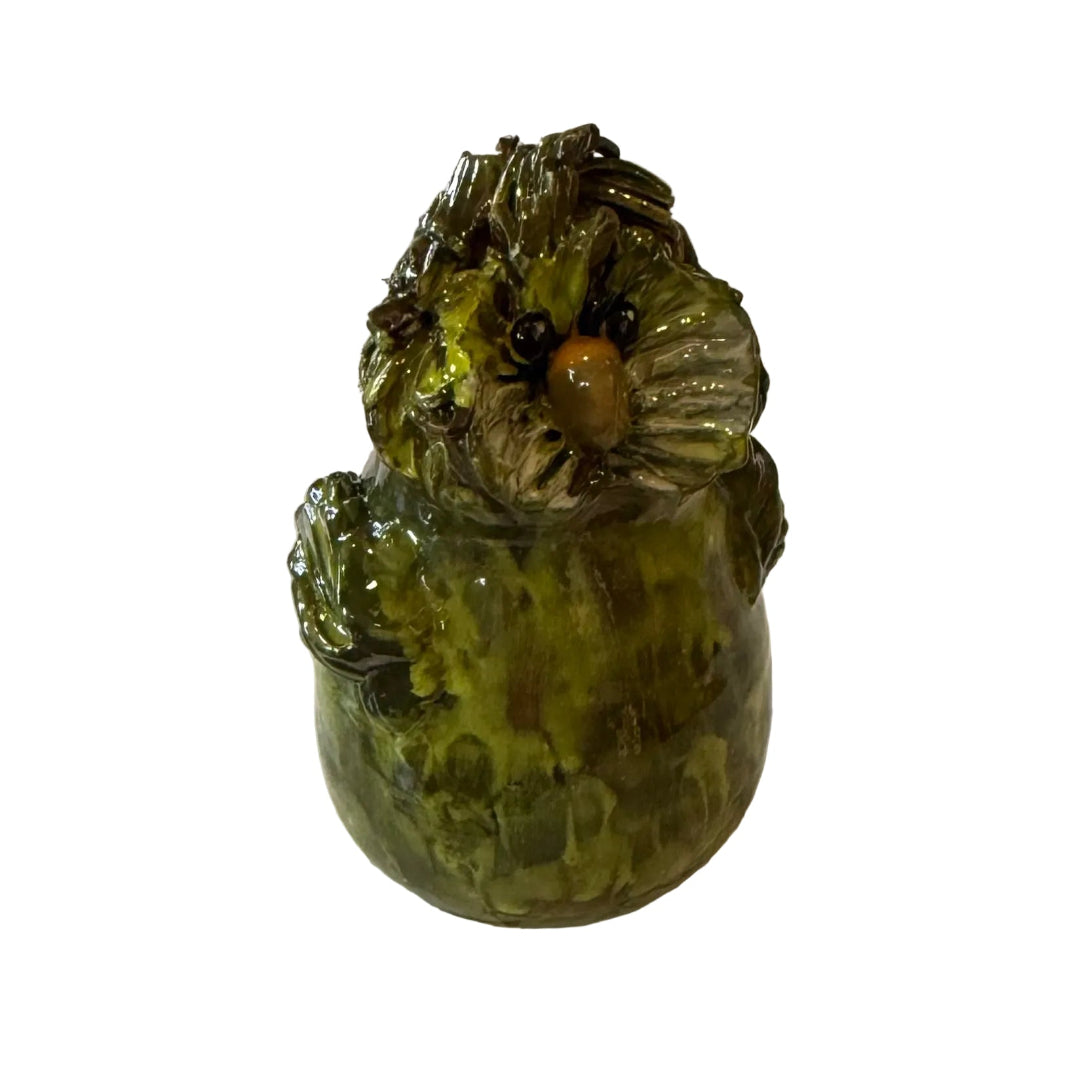 Ceramic Kakapo bird sculpture with an orange beak on a white background