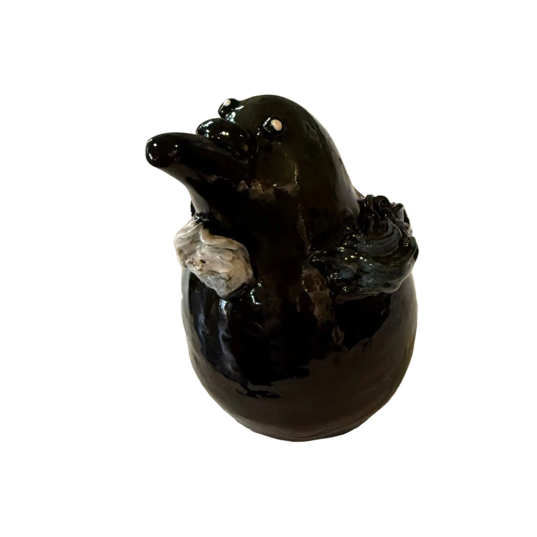 lack & blue ceramic Tui bird sculpture on a white background