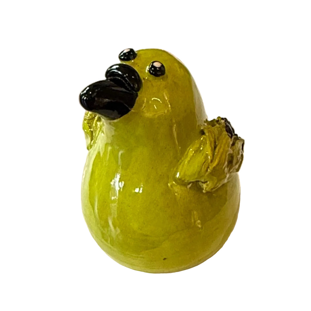 Ceramic Bellbird sculpture with a black beak on a white background