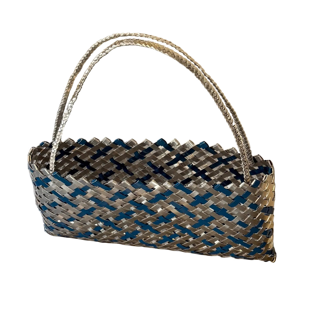 Woven teal blue and silver aluminium kete or bag on a white background
