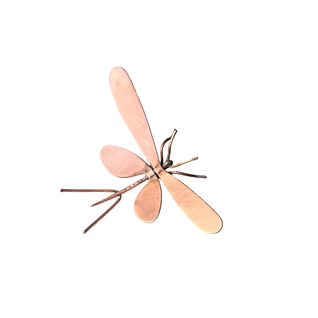 Copper mayfly sculpture on a white surface
