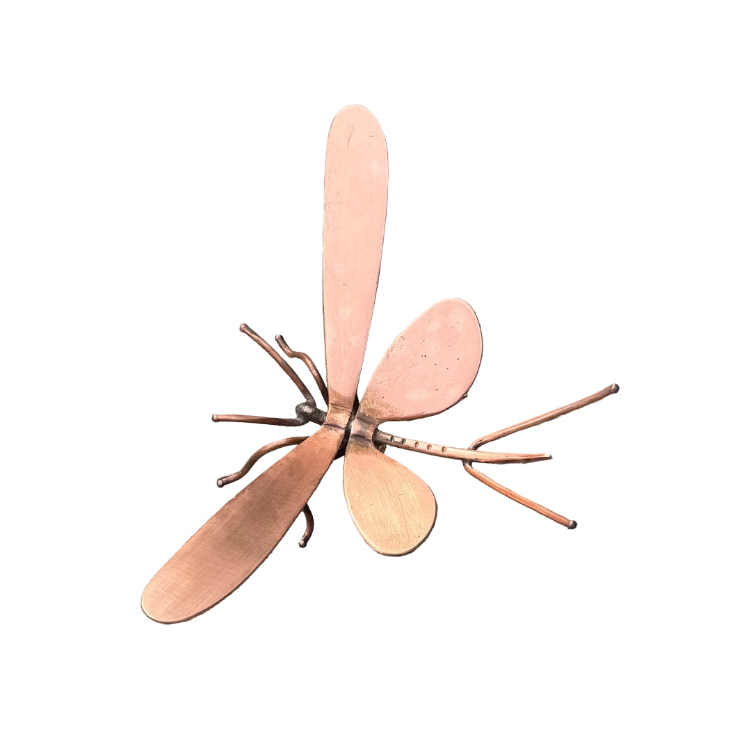 Copper mayfly sculpture on a white surface